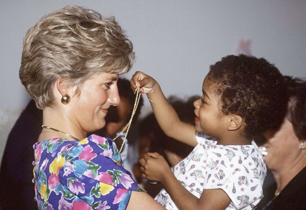 PHOTO: Princess Diana, Princess of Wales is seen cuddling a child during a visit to a hostel for abandoned children many of whom are HIV positive or suffer from AIDS on April 24, 1991, in Sao Paolo, Brazil.