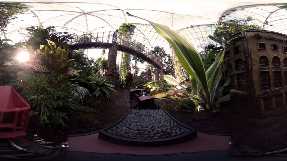 A model train chugs past miniature landmarks made from plant materials at the New York Botanical Garden.