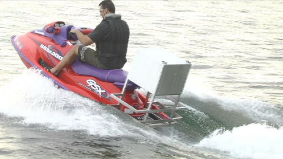 PHOTO: Nick Ferrugia, Long Lake Grocery owner, wears a life jacket to deliver pizzas on his jet ski in this frame grab from an undated video.
