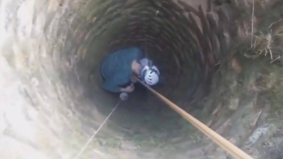 PHOTO: Christmas the dog is seen here being rescued from a well in Bosnia last week.