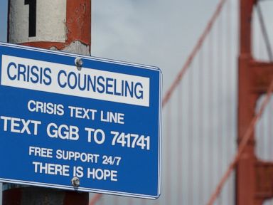 PHOTO: A suicide prevention sign is posted at the Golden Gate Bridge, on April 13, 2017, in San Francisco. Local officials gathered Thursday at the orange-red span to mark the beginning of work to line both sides of the bridge with steel netting.