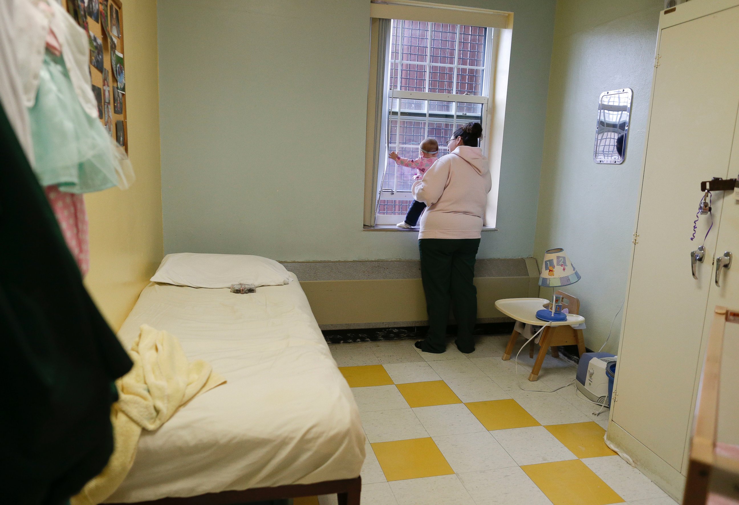 PHOTO: Jennifer Dumas looks out the window with her daughter, Codylynn, inside her room at Bedford Hills Correctional Facility, in Bedford Hills, N.Y., April 12, 2016.