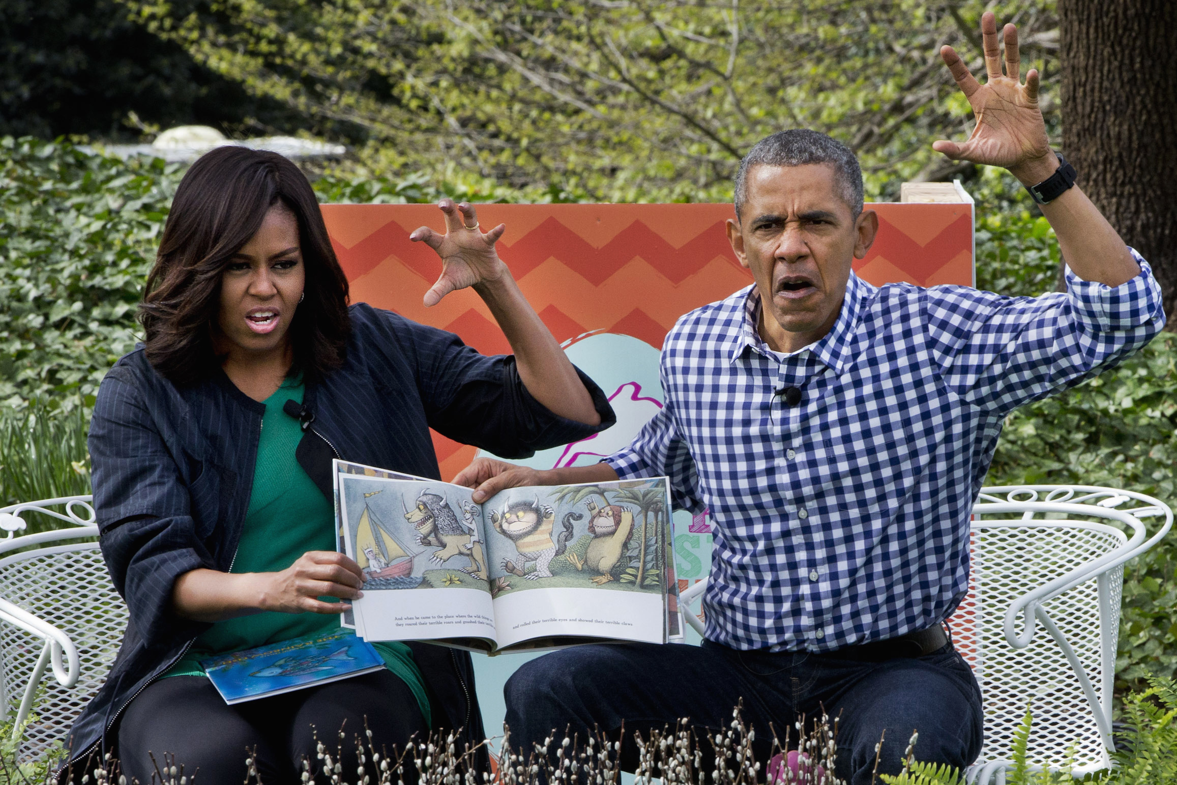 PHOTO: President Barack Obama and first lady Michelle Obama make claw hands and monster faces while reading, "Where The Wild Things Are," during White House Easter Egg Roll at the White House on March 28, 2016, in Washington.
