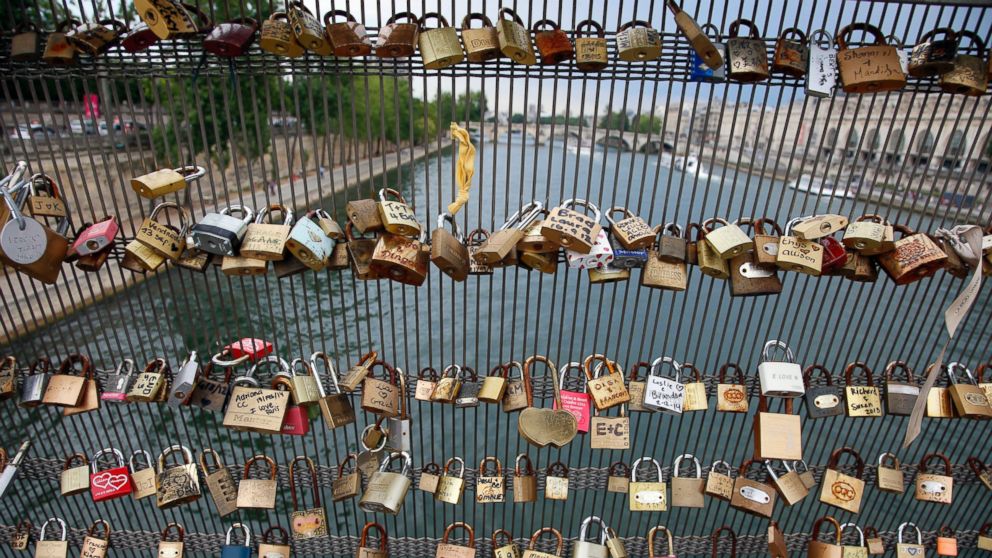 PHOTO: Love padlocks are seen on the Solferino bridge after a chunk of fencing with thousands of locks fell off under their weight on the Pont des Arts bridge, in Paris, June 9, 2014.