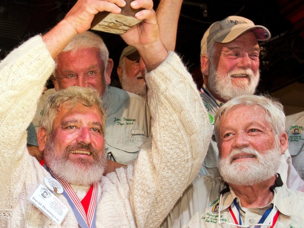 PHOTO: Dave Hemingway, center, hoists his trophy after winning the 2016 Ernest "Papa"  Hemingway Look-Alike Contest at Sloppy Joe's Bar in Key West, Florida, July 23, 2016.