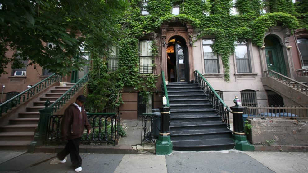 A person walks by the Langston Hughes House, center, covered in ivy plants, in  Harlem, New York, June 13, 2007.  