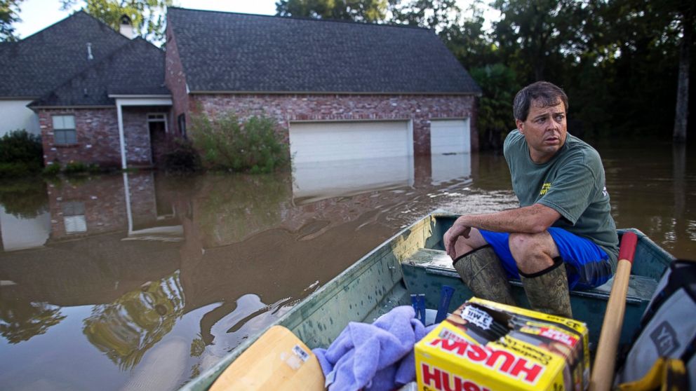 David Key boats away from his flooded home after reviewing the damage in Prairieville, Louisiana, Aug. 16, 2016.