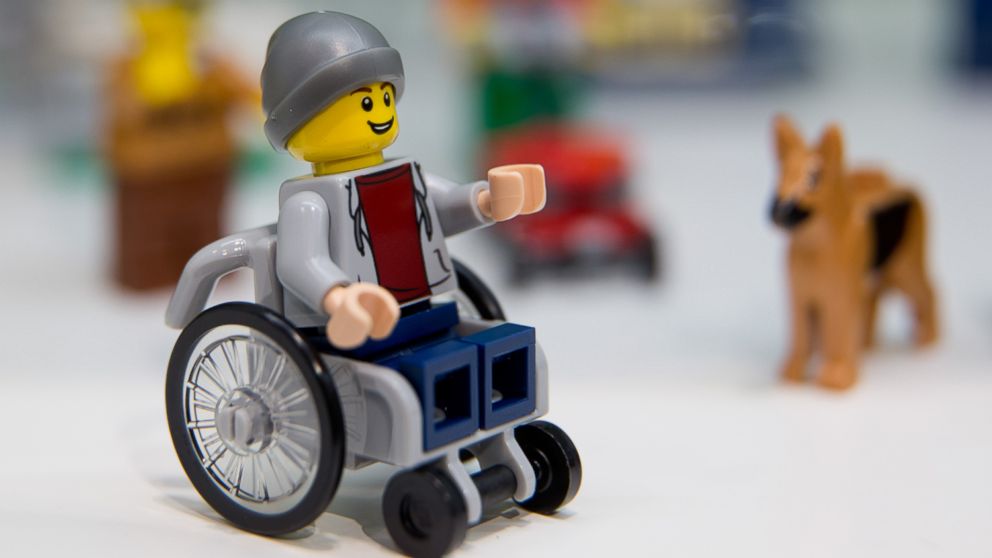 PHOTO: A Lego figure in a wheelchair can be seen next to a Lego dog at the stand for the Danish manufacturer Lego at the 67th International 'Speilwarenmesse'Â toy fair inÂ Nuremberg, Germany, on Jan. 28, 2016. 
