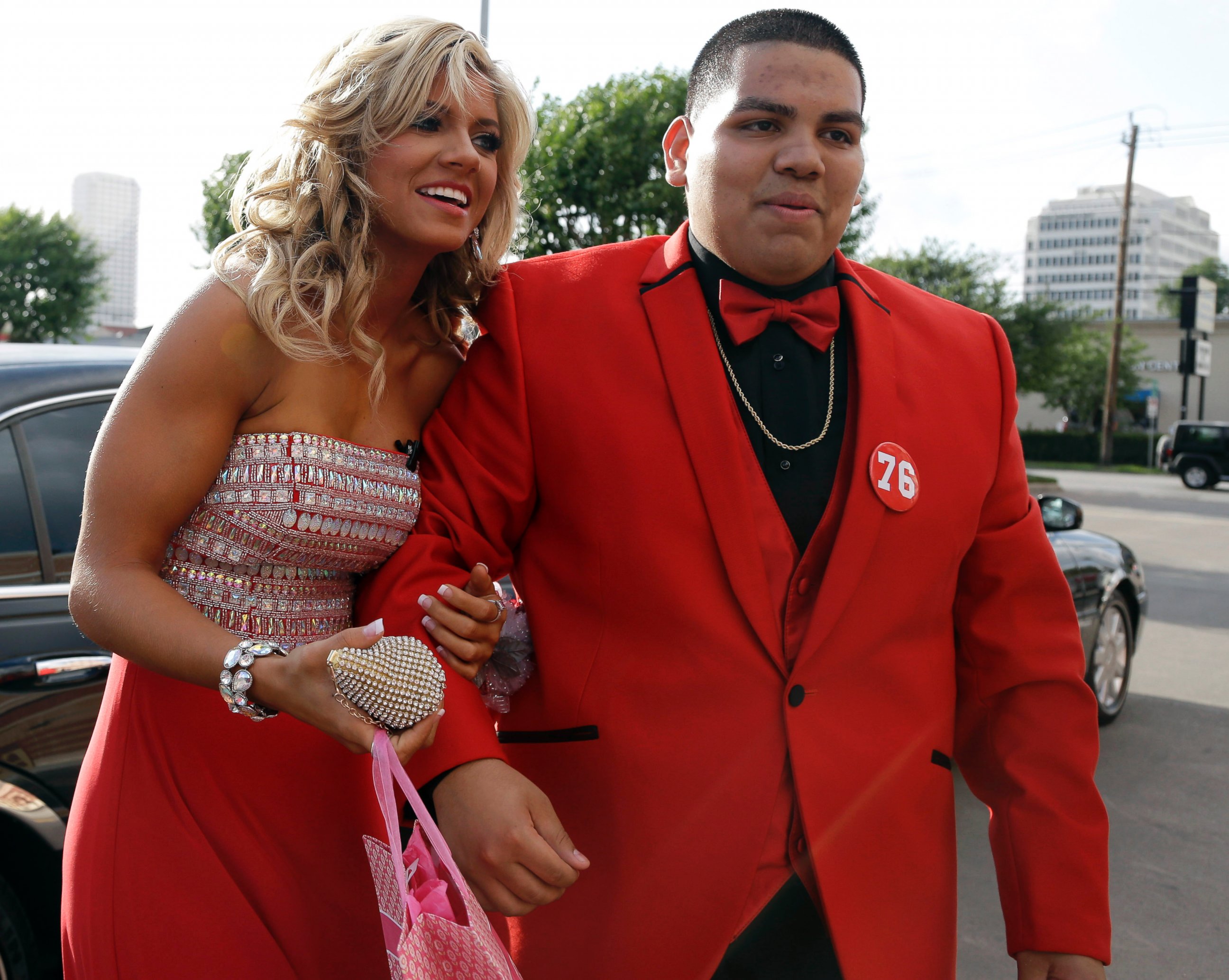 PHOTO: High school student Michael Ramirez, right, and Houston Texans cheerleader Caitlyn pose for pictures outside a restaurant before attending the prom Saturday, May 10, 2014, in Houston.