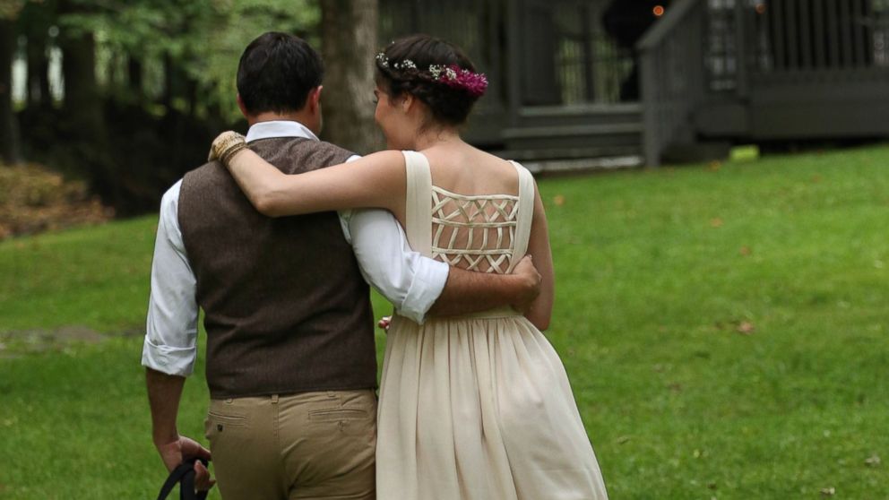 Daniel Dowd and Rebecca Blaine Carton embrace at their wedding.