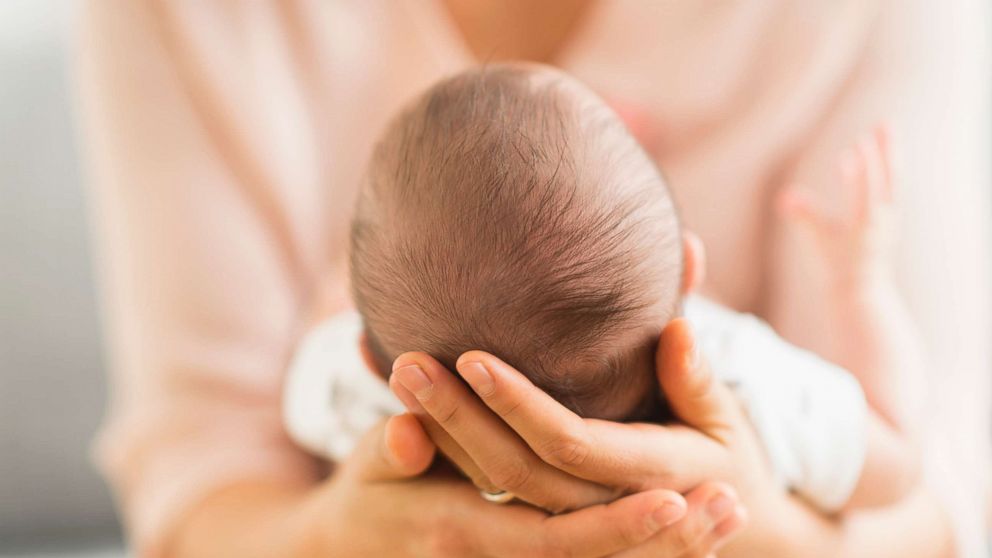 PHOTO:A woman holds a baby in this undated stock photo.