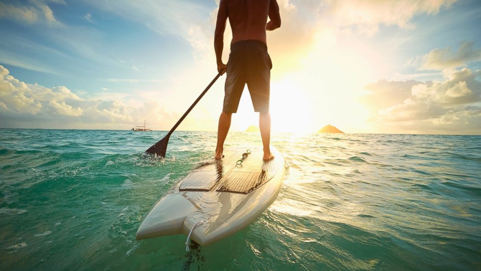 PHOTO: A man on a paddle board in the water.