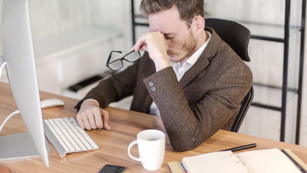 Businessman stressed out in front of a computer in this undated photo.