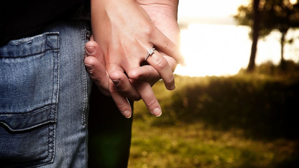 A couple with an engagement ring.