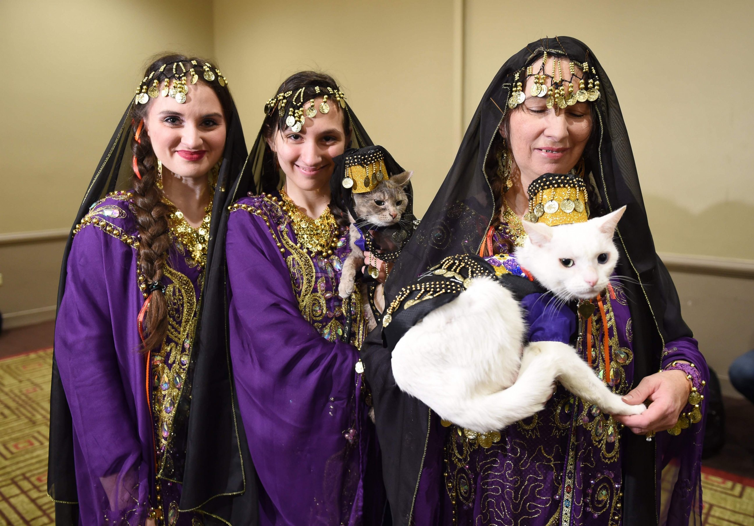 PHOTO: Women with their cats dressed in the fashion of Armenia pose during the 14th Annual New York Pet Fashion Show, Feb. 9, 2017. 