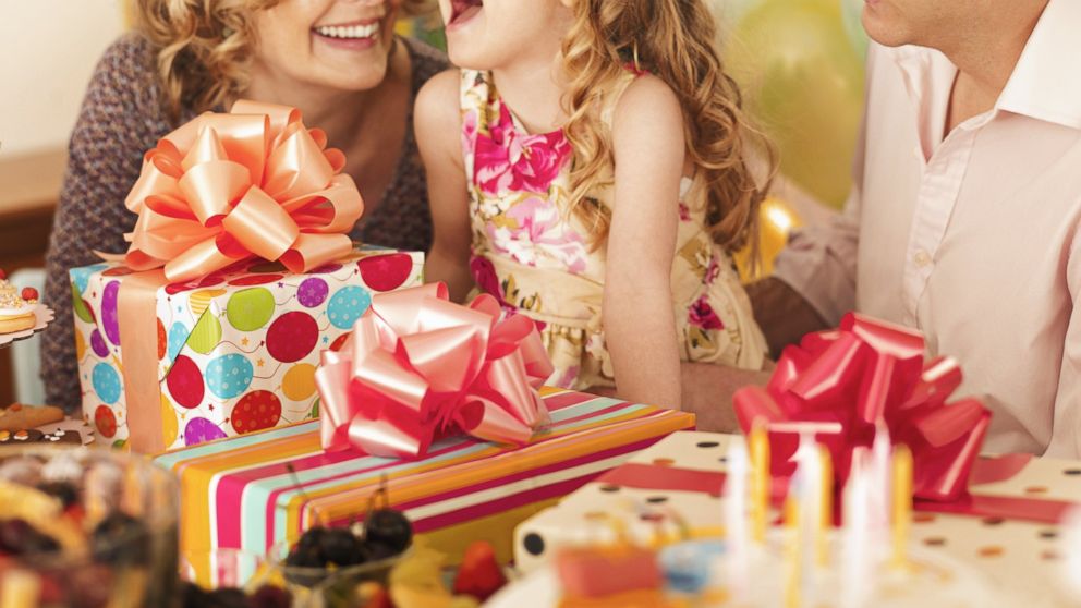 People are used to gift registries for weddings, but they're now becoming popular for a completely different kind of event: children's birthday parties. A Girl opens presents at birthday party in this undated stock photo. 