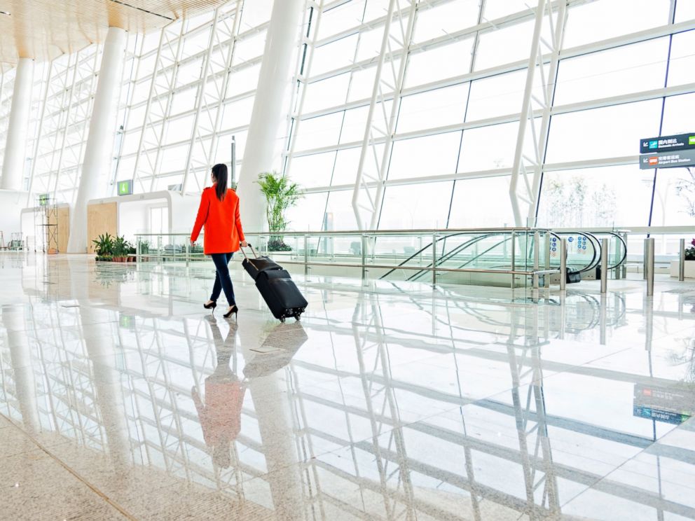 PHOTO: A young woman walks through the airport with luggage in this undated stock photo.