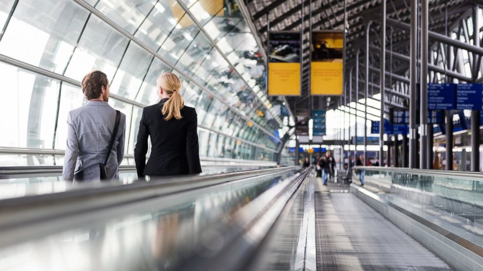 Two travelers talk at the airport in this undated stock photo.