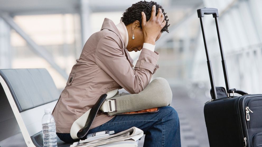 A woman waits for her flight at the airport in this undated stock photo.