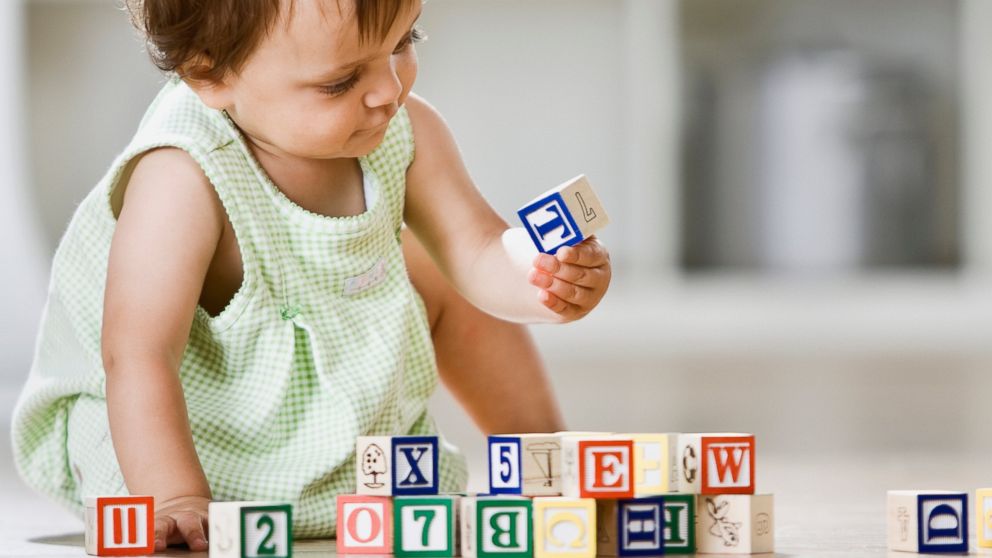 A baby plays with blocks in this undated stock photo.