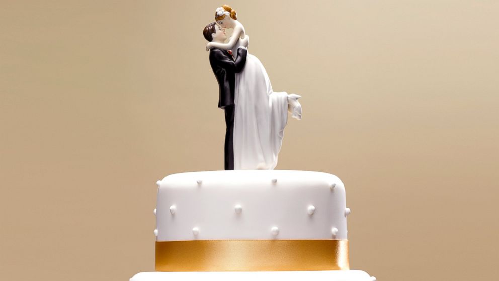 Bride and groom topper on a wedding cake.