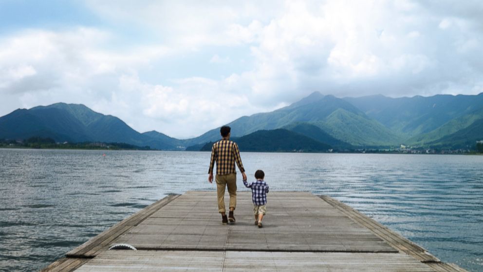PHOTO: A father and son walk on the pier overlooking a lake in this undated stock photo.