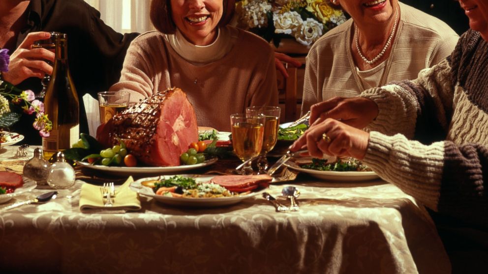A family is pictured eating a holiday dinner in this stock image. 