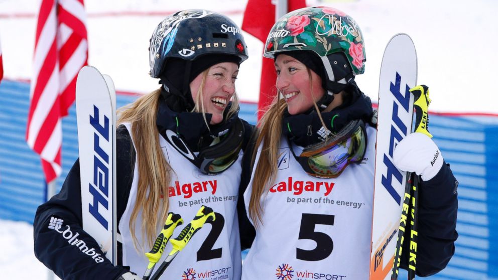 PHOTO: First place finisher Justine Dufour-Lapointe, left, and sister Chloe Dufour-Lapointe, third place,  smile at each other during the women's moguls finals at the FIS Freestyle Ski World Cup Jan. 4, 2014 in Calgary, Alberta, Canada.