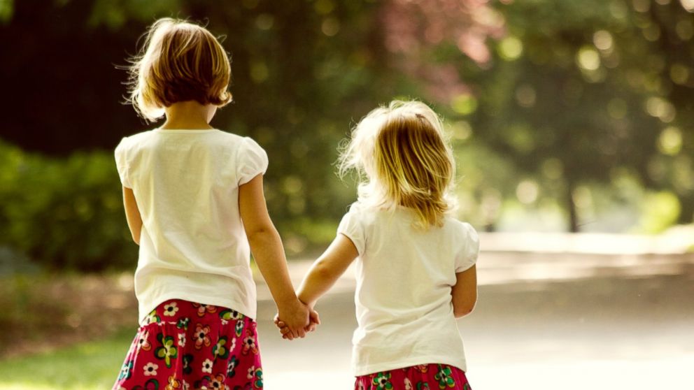 Two sisters take a walk together in this stock photo.