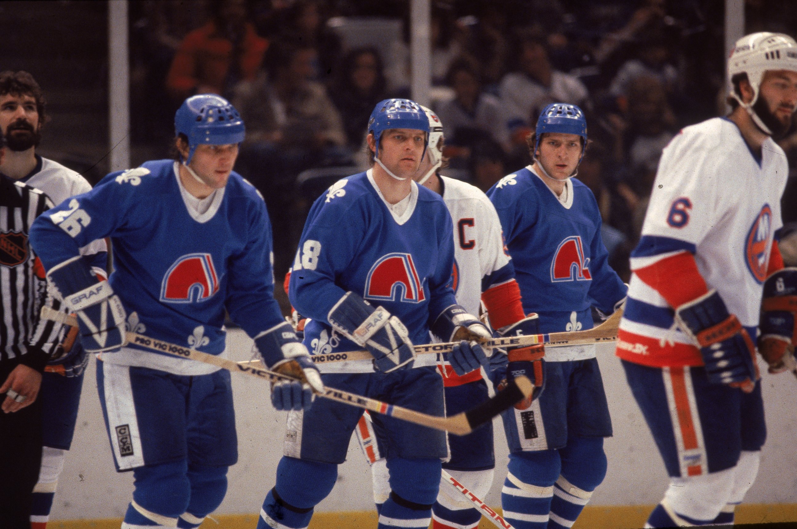 PHOTO: Czech ice hockey playing brothers, Peter Stastny (L)), Marian Stastny (C), and Anton Stastny, of the Quebec Nordiques are seen on the ice in a game against the New York Islanders at Nassau Coliseum in Uniondale, New York, early 1980s.