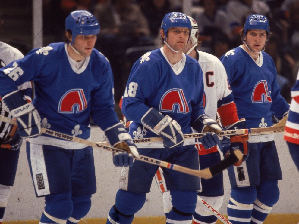 PHOTO: Czech ice hockey playing brothers, Peter Stastny (L)), Marian Stastny (C), and Anton Stastny, of the Quebec Nordiques are seen on the ice in a game against the New York Islanders at Nassau Coliseum in Uniondale, New York, early 1980s.