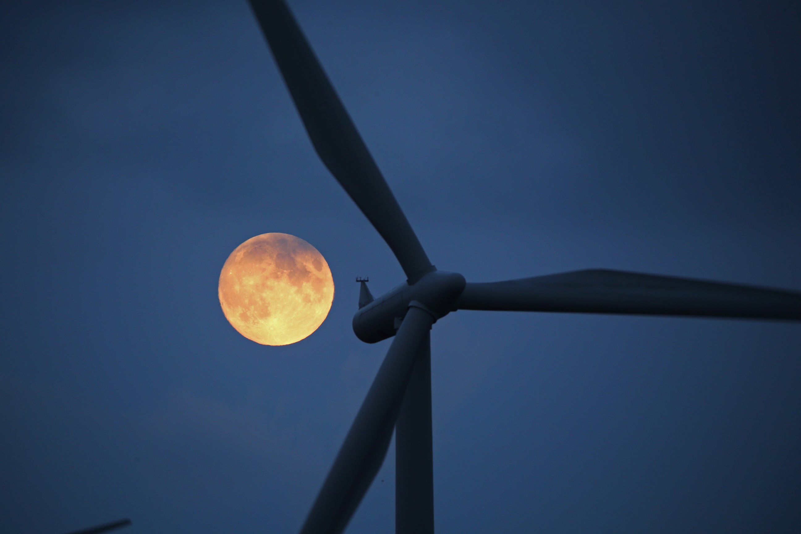 PHOTO: The moon rises behind the turbines of Whitelees Windfarm, Oct. 7, 2014, in Glasgow, Scotland.