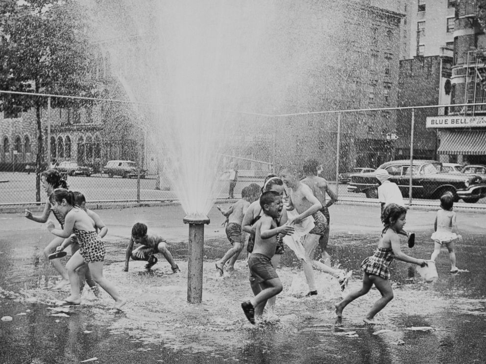 PHOTO: Children play in a sprinkler, circa 1965.