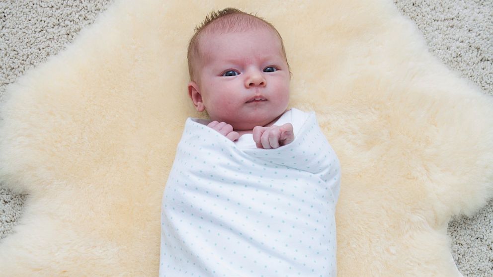 baby in swaddling clothes