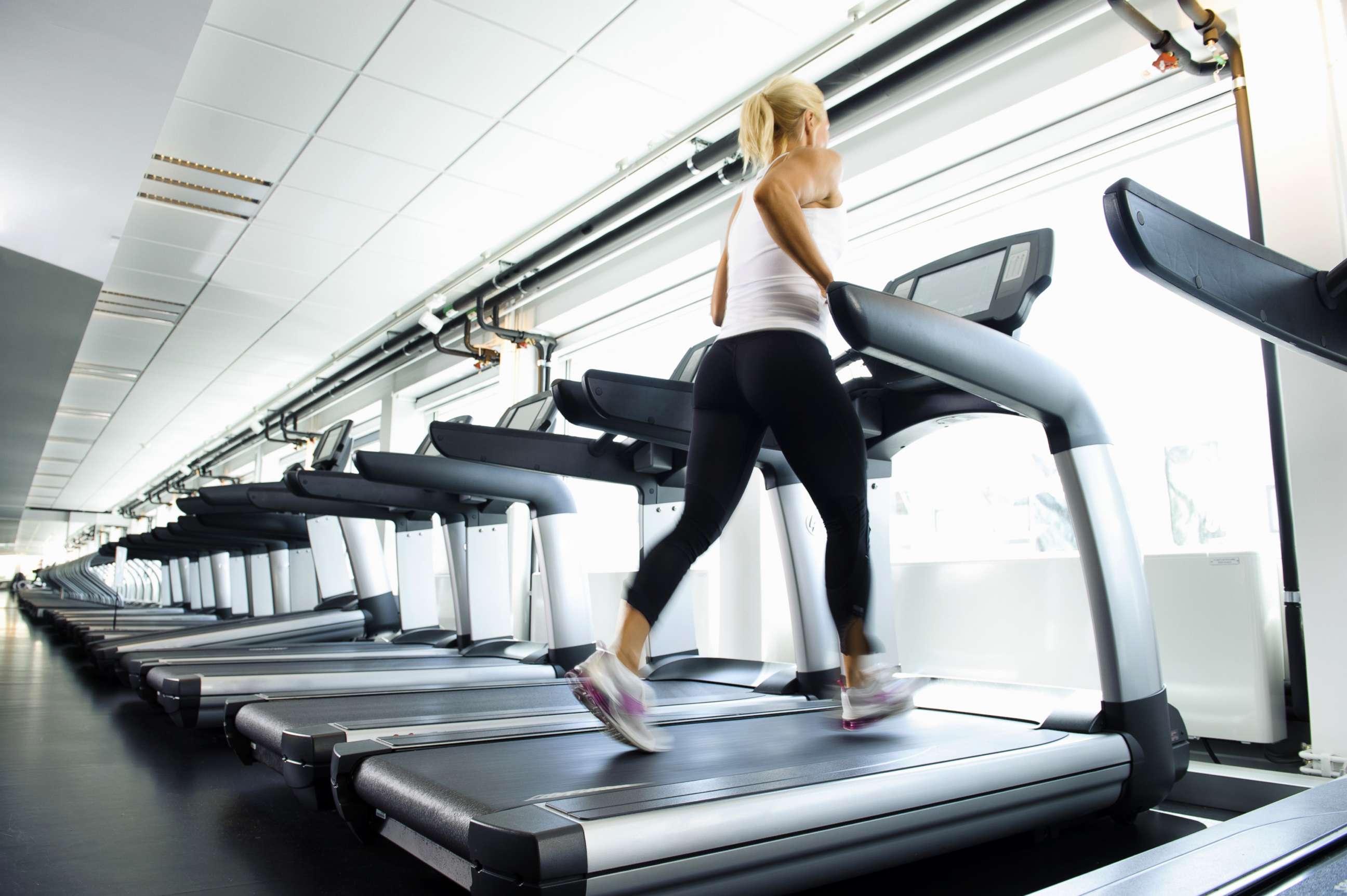 PHOTO: A woman works out on a treadmill.
