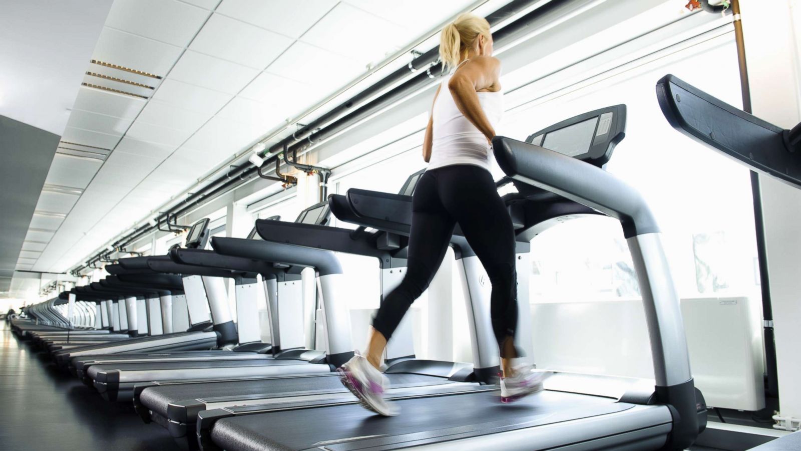 PHOTO: A woman works out on a treadmill.