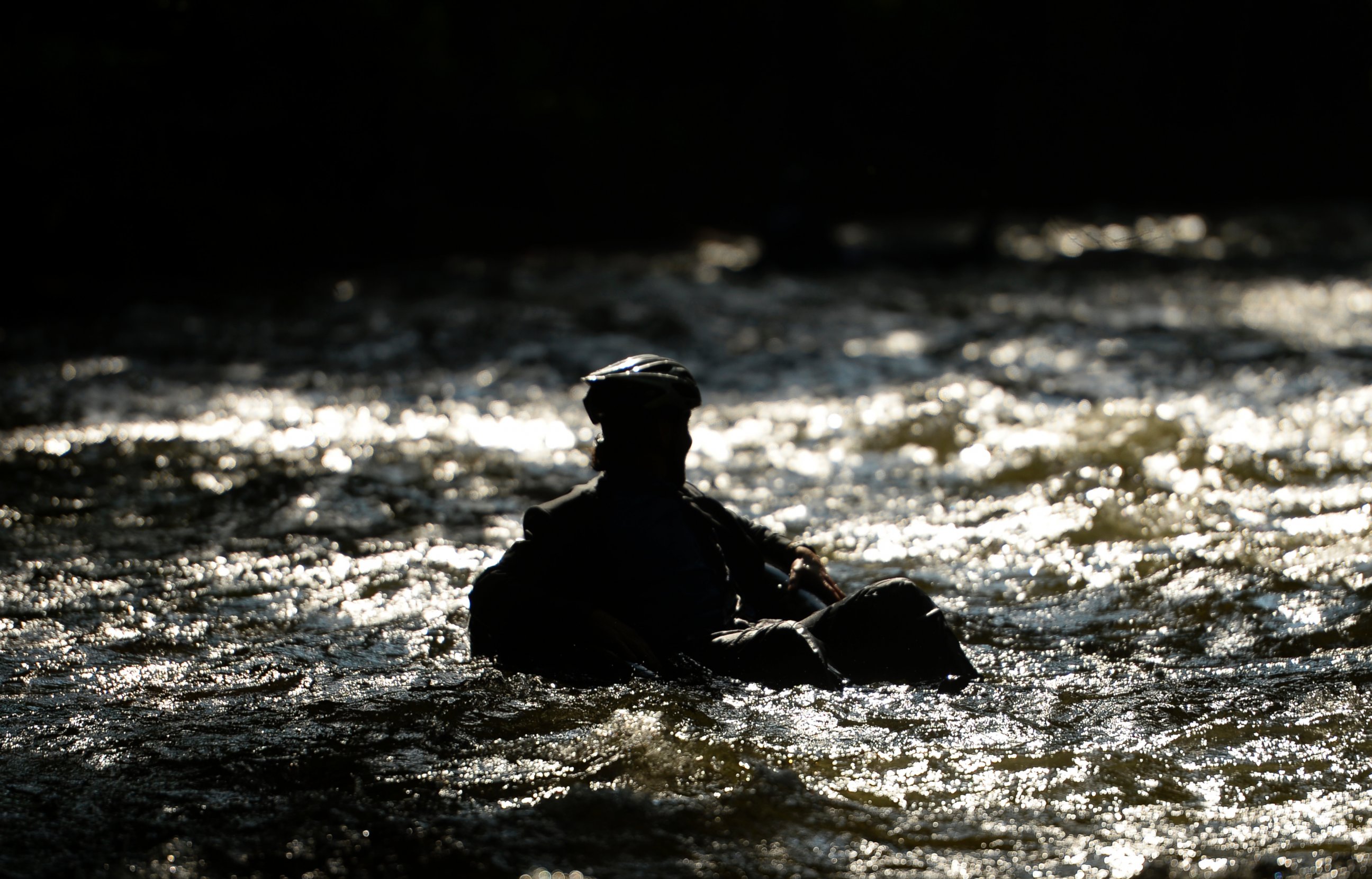 PHOTO: Quayle Hodek, dressed in a suit and tie, floats down Boulder Creek during Boulder's Tube to Work Day, July 15, 2014. 