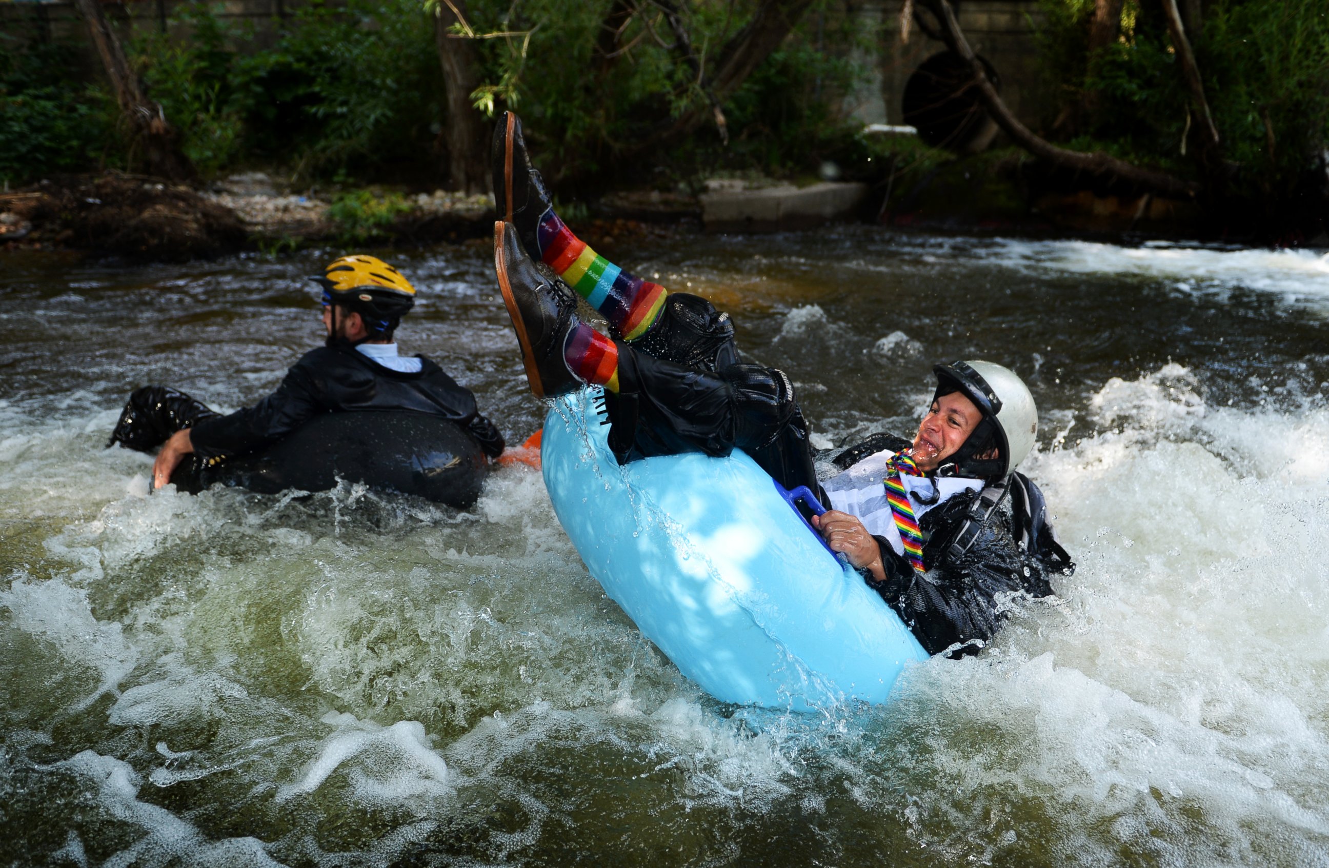 PHOTO: Jeff Kagan, left, is the founder of the seventh annual Boulder's Tube to Work Day, July 15, 2014. Around 40 participants took their tubes down Boulder Creek on their way to work. 