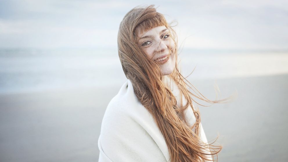 In this stock image, a woman with windswept hair is pictured. 