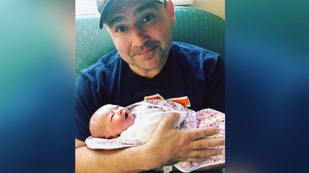 PHOTO: Will Settle holds his newborn girl, Carter Louise Settle, born June 25.