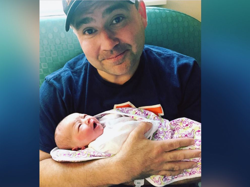 PHOTO: Will Settle holds his newborn girl, Carter Louise Settle, born June 25.