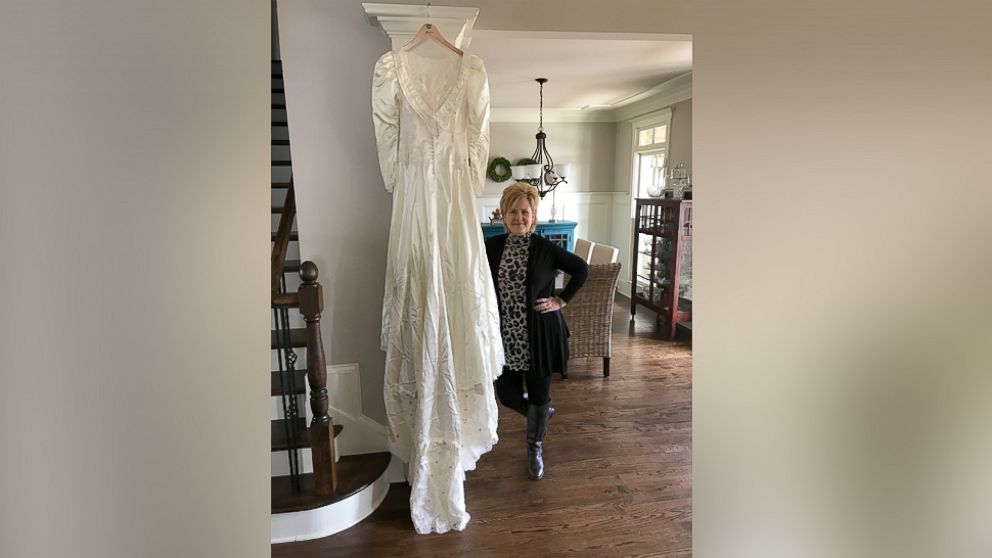PHOTO: Kim Jones, 52, of Acworth, Georgia, poses with the wedding dress of Shannon McNamara.