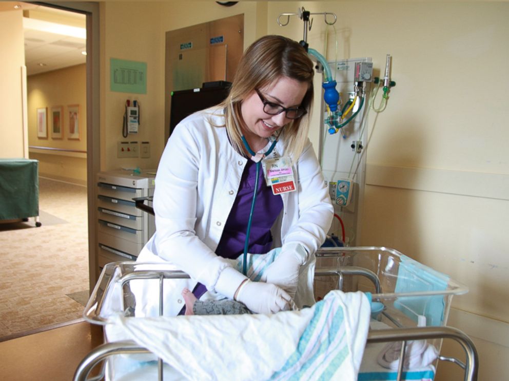 PHOTO: Neonatal nurse Melissa Jordan of CaroMont Health in Gastonia, North Carolina, celebrates the babies leaving the neonatal intensive care unit with a scheduled photo shoot and an academic cap.
