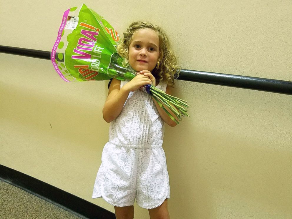 PHOTO: Little Sophia, 4, celebrates with flowers after her extremely passionate performance at her graduation ceremony.