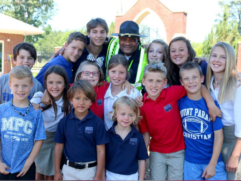 PHOTO: Jonathan Broadnax, the security guard at Mount Paran Christian School, was bombarded with hugs from students on the last day of school.