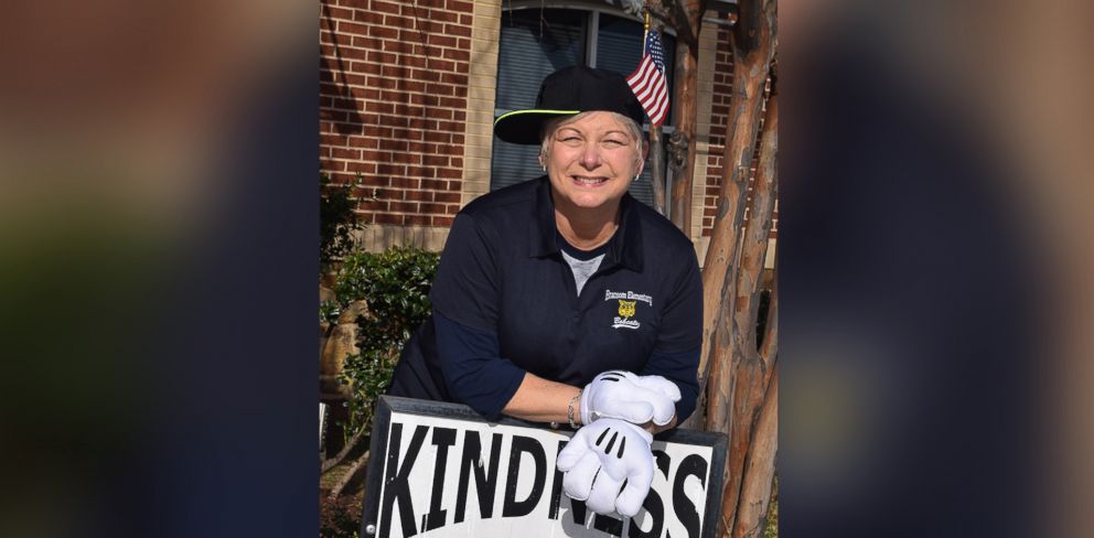 PHOTO: Cindy Matthews, a teacher's assistant at the Academy of the Arts at Bransom Elementary in Burleson, Texas, greets students in silly costumes every morning. Here she is shown wearing her flag hat.