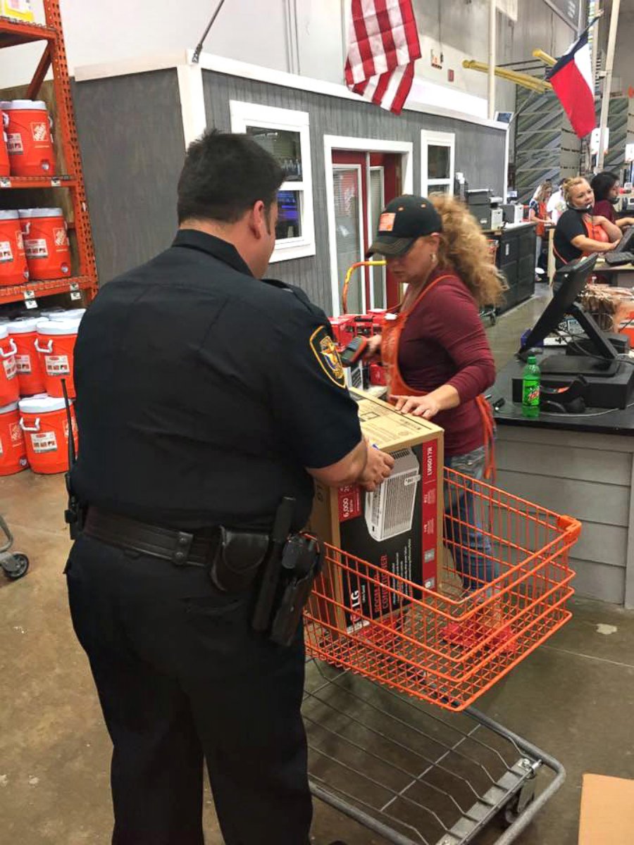 PHOTO: Officer Christopher Weir, Officer William Margolis (seen in photo) and an employee of Home Depot pitched in to help out Julius Hatley, 95, who was left without air conditioning on a 90-degree day in Texas.