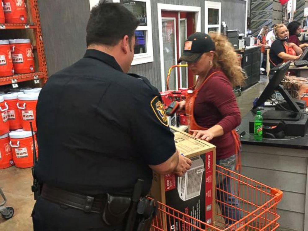 PHOTO: Officer Christopher Weir, Officer William Margolis (seen in photo) and an employee of Home Depot pitched in to help out Julius Hatley, 95, who was left without air conditioning on a 90-degree day in Texas.