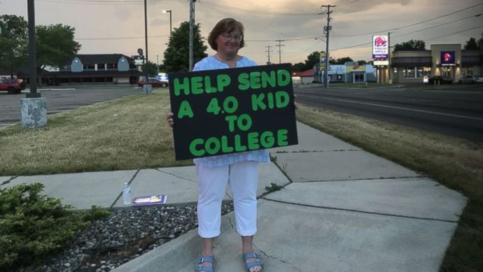 Lori Truex of Battle Creek, Michigan, stands in various locations in her city while holding a sign asking strangers to contribute to her daughter's college fund.  