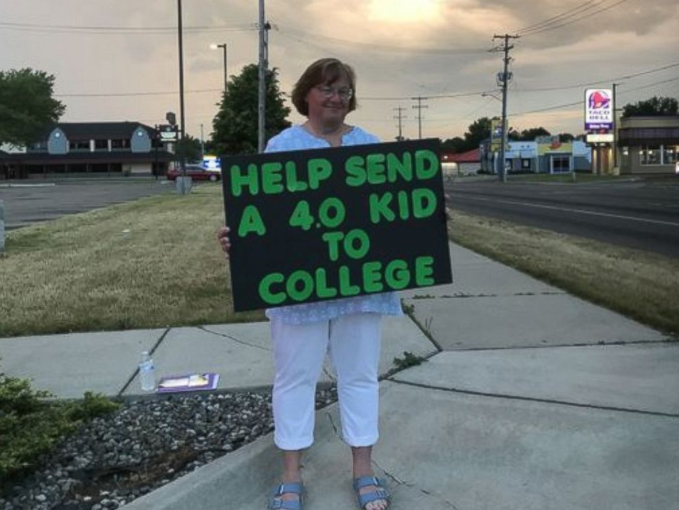 PHOTO: Lori Truex of Battle Creek, Michigan, stands in various locations in her city while holding a sign asking strangers to contribute to her daughter's college fund. 